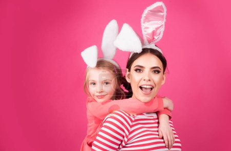 Girl friends happy easter. Happy childhood concept. Small sister female bunny ears isolated on pink background