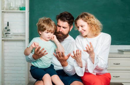 Photo for Little ready to study. Mother father and son together schooling - Counting on fingers. Kids at preschool. Teachers day. Parent taking child to school. First day at school - Counting - Royalty Free Image