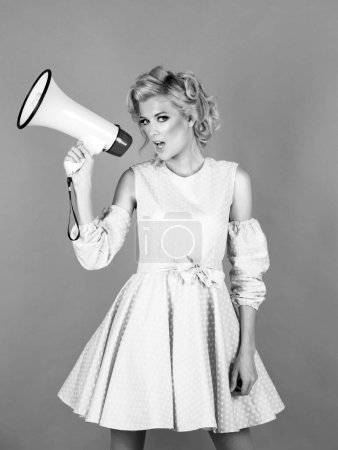 Woman screaming in megaphone isolated on pink background studio portrait. Beauty woman with megaphone isolated on pink
