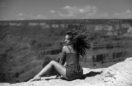 Photo for Travel and adventure concept. Elegant woman on grand canyon. Young Woman enjoying scenic dramatic view of american national park - Royalty Free Image