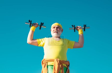 Old man holding his hands in front of him while lifting dumbbells. Grandfather exercising with dumbbell. Sport for senior man