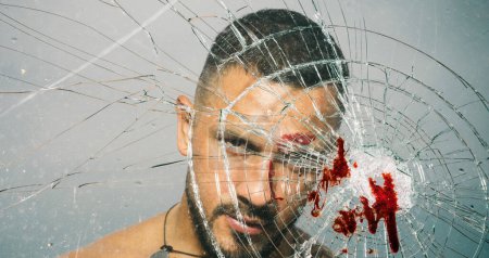 Photo for An ill wound is cured. Hispanic man bleeding from bullet wound. Latino man with blood wound on face and broken glass. Handsome wounded guy with skin deep injury wound. - Royalty Free Image
