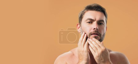 Beautiful man with clean perfect skin. Beauty male skin care. Cosmetology cosmetics beauty and spa. Male facial treatment and wellness. Banner for header, copy space. Poster for web design