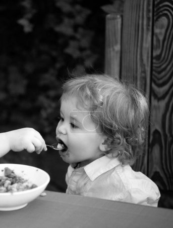 Photo for Baby eating kids food. Healthy kids breakfast - Royalty Free Image