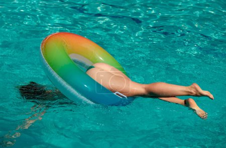 Sexy woman in swimming pool. Buttocks in bikini. Summer vacation