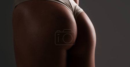 Foto de Young sexy woman butt closeup. Beautiful lady in erotic lingerie. Beauty woman with attractive buttocks in lace lingerie. Female ass in underwear. Naked models - Imagen libre de derechos
