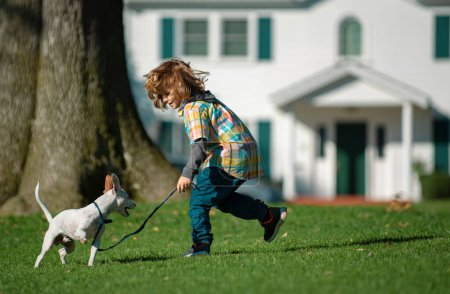 Photo for Child and Puppy. Best friends kid boy and puppy rest and have fun on vacation. Happy childhood - Royalty Free Image