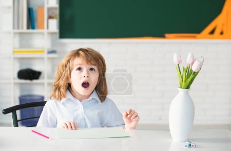 Photo for Surprised pupil. Elementary schoolboy education. Portrait of Pupil of primary school study indoors. After school teaching. Kid gets ready for school - Royalty Free Image