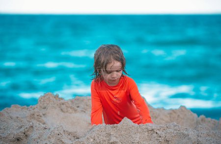 Photo for Child making sand castle at beach on sea - Royalty Free Image