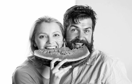 Photo for Happy face closeup of couple enjoying watermelon. Cheerful couple holding slices of watermelon. Funny face - Royalty Free Image