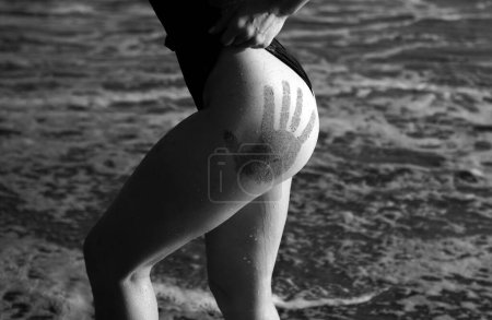 Photo for Closeup womans butt. Sexy buttocks in bikini on malaysia or dominican, sea background - Royalty Free Image