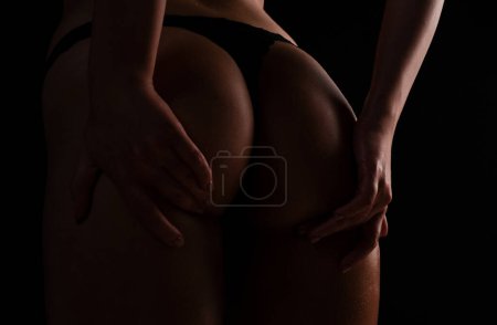Foto de Intimacy concept. Cropped close up buttocks, lover in bikini with sexy butt. Nice ass. Sexy woman in underwear with perfect curves. Female ass in lingerie - Imagen libre de derechos