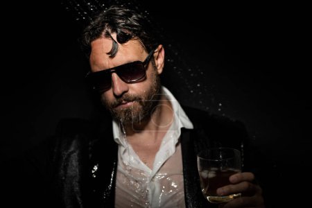 Photo for Night lifestyle. Disheveled man in suit in bathroom after night party. Man drinking a whiskey after party in night club. Alcohol and drugs concept. Stressed business man under shower in bath at night - Royalty Free Image