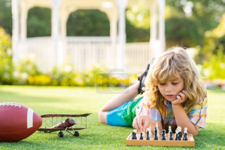 Kid thinking of chess. Smart kid playing chess. Clever child thinking about chess. Intelligent, smart clever kids. Games good for brain intelligence concept