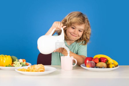 Photo for Child drink dairy milk. Kid pours dairy milk - Royalty Free Image