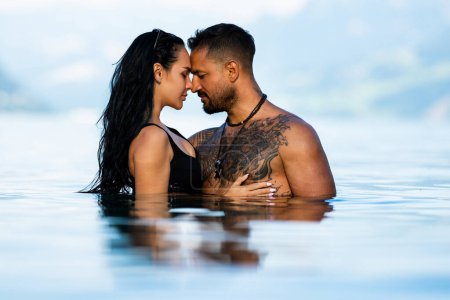 Photo for Summer sexy couples. Romantic couple in sea water. Beautiful young couple in love on the lake. Sexy couple kissing by the sea. Dream vacation. Sex on the beach. Erotic couple kissing in the water - Royalty Free Image