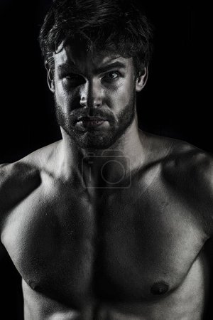 Photo for Sexy naked muscular man. Sexy handsome playboy on black. Handsome muscular man relaxing. Portrait of a sexy man with naked muscular body. Strong athletic man. Fit male model - Royalty Free Image