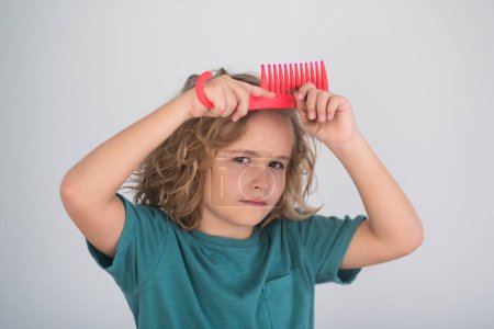Photo for Kids hair. Kids barber shop. Child with curly hair hold hairbrush or comb. Healthy hair. Kid brushing unruly tangled hair - Royalty Free Image