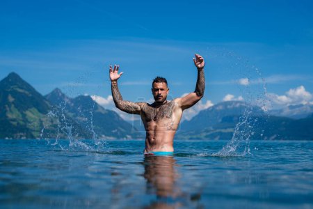 Photo for Sexy man in water. Seductive face of a sexy guy. Handsome shirtless man in nature. Muscular male fit body. Strong athletic man. Fit male model. Healthy handsome Athletic Man outdoor - Royalty Free Image