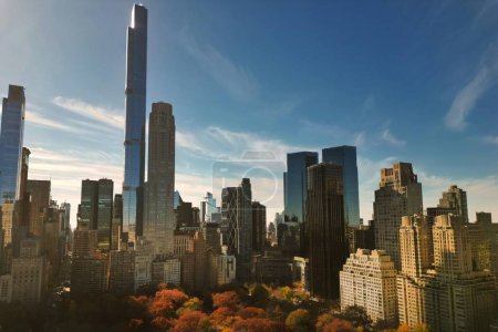 Photo for Autumn Central Park in New York with skyscrapers view from drone. Aerial of NYC Central Park panorama in Autumn. Autumn in Central Park. Autumn NYC. Central Park Fall foliage - Royalty Free Image