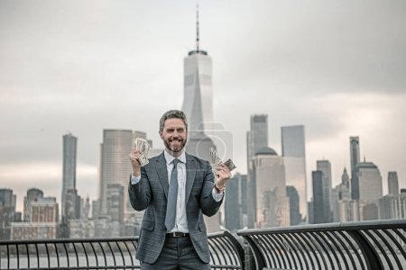 Photo for Businessman hold money in New York. Business man with dollars outdoor. Wealth rich businessman millionaire in suit holding money. Mature businessman winner celebrating success. Finance and banking - Royalty Free Image