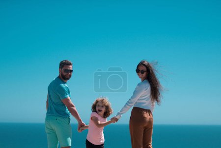 Photo for Weekend family concept. Happy family holidays. Joyful father, mother, baby son walk of sea sand beach. Active parents and people outdoor activity on summer vacations with children - Royalty Free Image