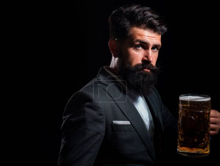 Portrait of serious man holds craft beer isoalted on black, copy space