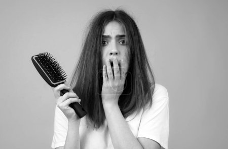Photo for Haircare. Straightening woman and treatment of the hair. Girl with straight brushed hair. Hair tangling problem. Damaged hair combing - Royalty Free Image