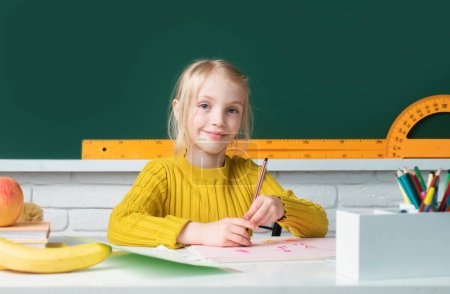 Photo for School girl studying math on lesson in classroom at elementary school. Education, learning and children concept - Royalty Free Image
