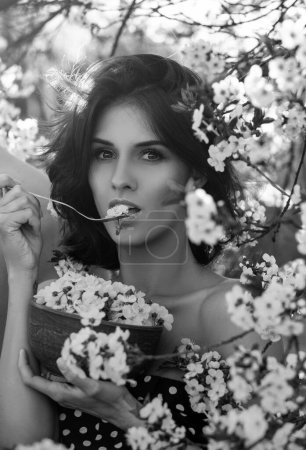 Photo for Helthy food concept. Vegan vegetarian woman with plate of bloom blossom flowers - Royalty Free Image