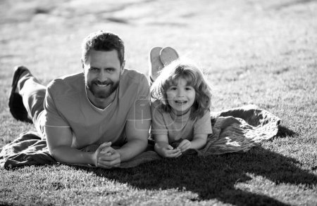 Photo for Father and son relaxing on nature in park. Childhood and parenthood kids concept. Happy dad and child playing together outdoor - Royalty Free Image