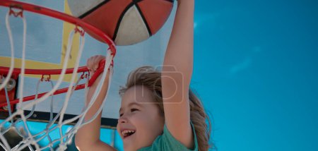 Photo for Basketball Slam Dunks of sporty kids basketball player. Child sport activity - Royalty Free Image