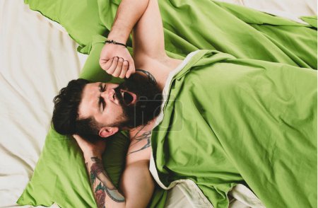 Photo for Man is lying on bed and enjoying the morning. Man having problems with sleep. Bearded man wake up on bed in bedroom - Royalty Free Image