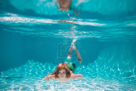 Photo for Young boy swim and dive underwater. Under water portrait in swim pool. Child boy diving into a swimming pool. Summer kids in water in pool underwater - Royalty Free Image
