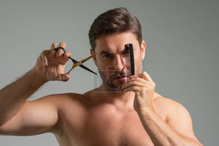 Photo for Mens hairstyle, haircut. Millennial man with scissors cut hair. Mens haircare, beauty barber concept. Bearded man, with scissors. Cut hair with scissors. Man hair styling and cut hair with scissors - Royalty Free Image
