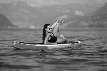 Photo for Woman Kayaking of Lake. Summer beauty sexy woman outdoor portrait. Young woman canoeing in the lake on a summer day, background alps mountains - Royalty Free Image