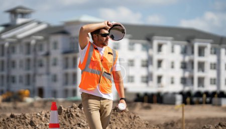 Photo for Tired worker. 40s worker builder man on site construction. American middle aged man worker. Millennial construction worker with at building - Royalty Free Image