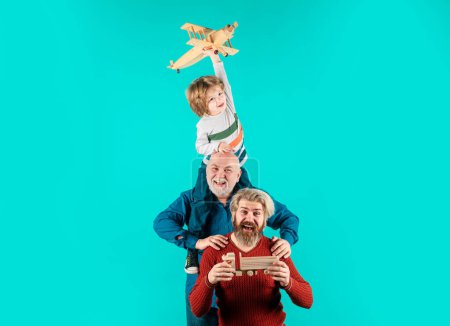 Photo for Fathers day. Kid having fun with toy plane. Men generation family with different generations ages grandfather father and son - Royalty Free Image