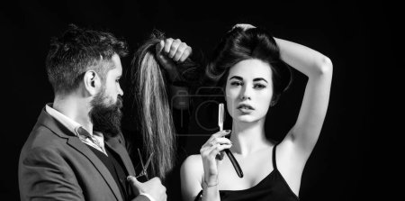 Hairdresser makes hair style with hair care products. Hairdresser making hairstyle, haircut. Woman with long hair at beauty salon. Barber cutting hair with scissors