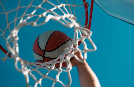 Photo for Hands and basketball. Scoring the winning points at a basketball game. Basketball as a sports and fitness symbol of a team leisure activity playing outdoor - Royalty Free Image