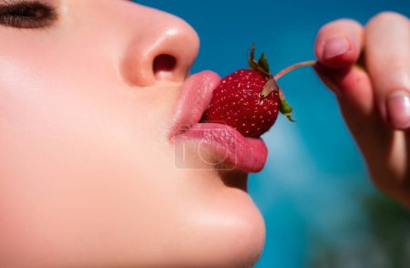 Strawberry in lips. Red strawberry in woman mouths close up. Summer sexy fruits. Beautiful girl, strawberries in mouth