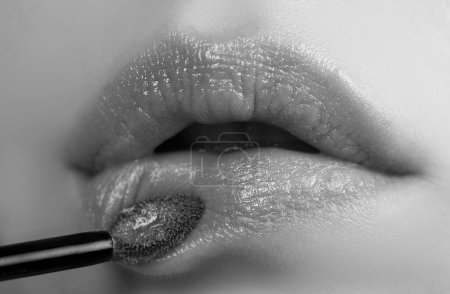 Photo for Lips lipstick closeup. Applying makeup on lip. Pampering, lips correction concept - Royalty Free Image