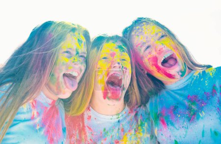 Photo for Teenager friends with dry colors. Drycolors. Teenage school friends having fun piggybacking outdoors with dry colors. Happy mood with colorful drycolors. Colorful holi on painted face - Royalty Free Image