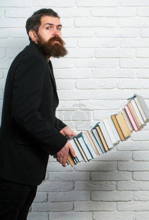 Photo for Books stacked fall. Portrait of a funny teacher or professor with book stack. Thinking serious mature teacher. Falling books concept. Mature professor, middle aged teacher, bearded fun man - Royalty Free Image