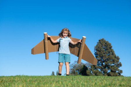 Photo for Dreams of travel. Child flying on jetpack with toy airplane on sky background. Happy child boy playing in cardboard plane. Kid having fun outside. Kid journey, travel and trip concept - Royalty Free Image