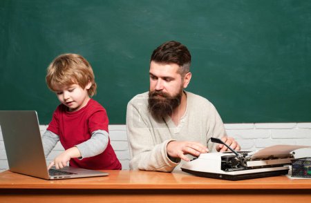 Photo for Teacher teaches a student to use a microscope. Happy family - daddy and son together. Man teaches child. Homeschooling. Elementary school teacher and student in classroom. - Royalty Free Image