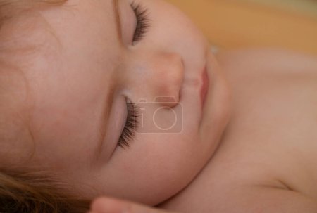 Photo for Close up face of baby child sleeping in the bed. Closeup sleepy kids portrait - Royalty Free Image