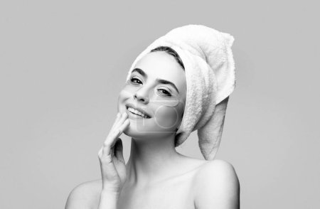 Photo for Happy woman applying eye patches. Close up portrait girl with towel on head. Portrait of beauty woman with eye patches showing an effect of perfect skin - Royalty Free Image
