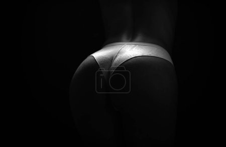 Foto de Female butt in sexy bikini. Erotic lingerie. Bondage and bdsm concept. Seductive temptress. Slim woman dressed in lace lingerie - Imagen libre de derechos