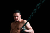 Seductive face of a sexy man athlete holding a chain. Macho looking confident. Strong muscular male body, muscles guy puzzle #713747274